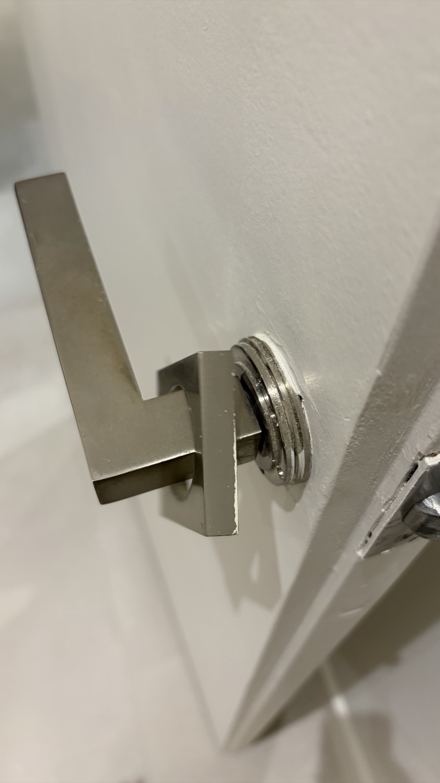 Handle trim plate sitting loose before being screwed down properly