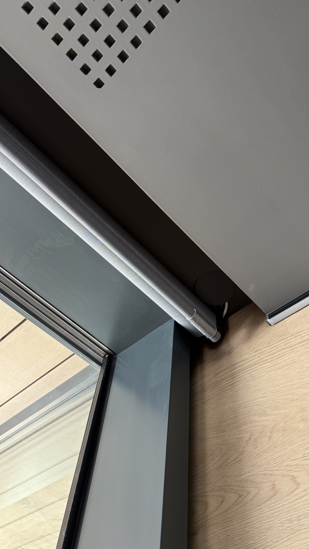 Motorized roller blind mounted to ceiling