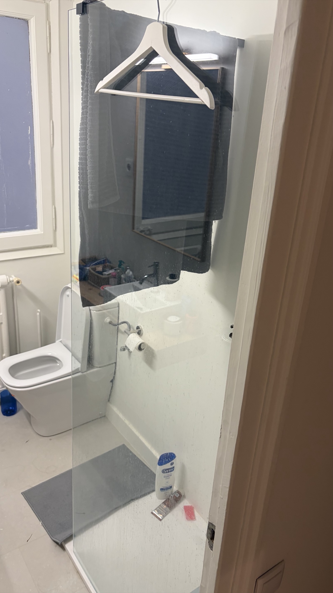 Fixed glass shower screen on walk-in tray