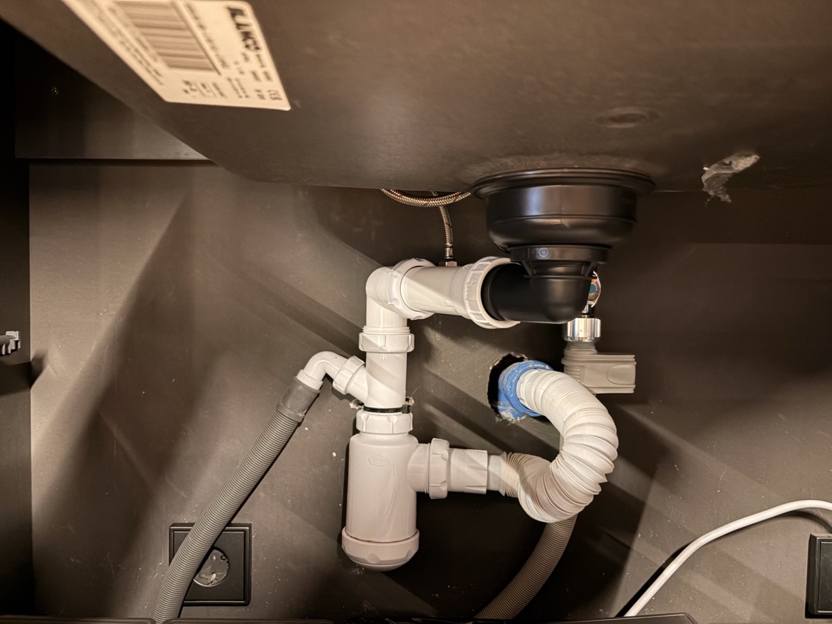 Under-sink plumbing showing P-trap and drain connections