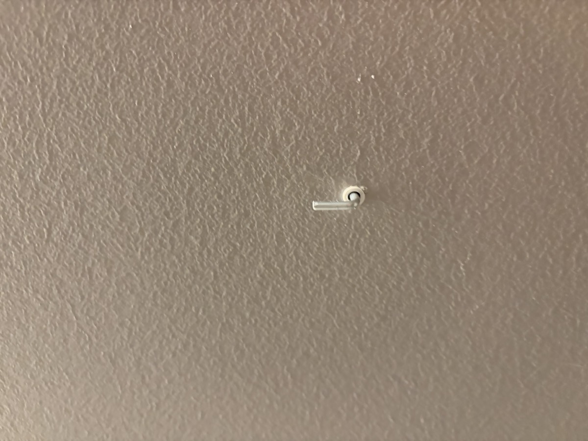 Clean wall anchor hole ready for patching with spackle