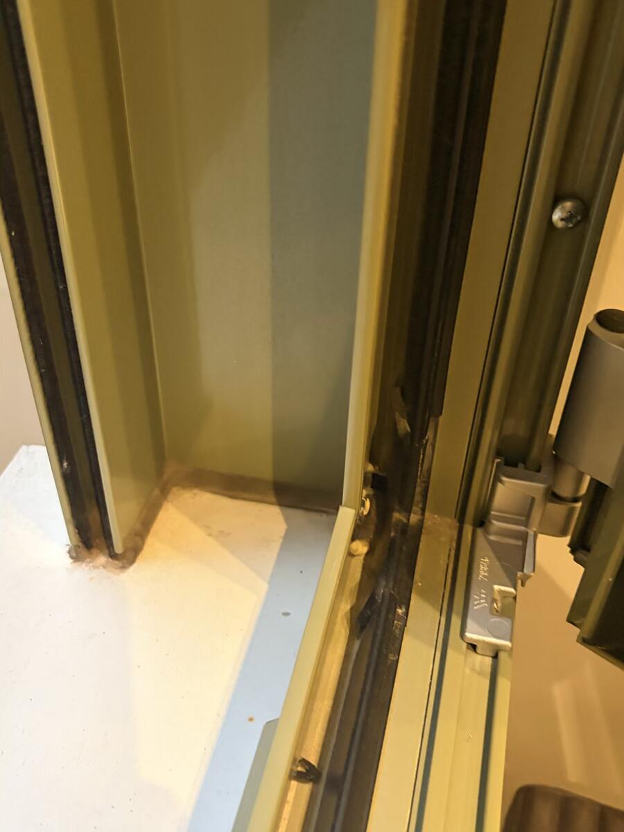 Dirty window track with accumulated dust and debris before cleaning